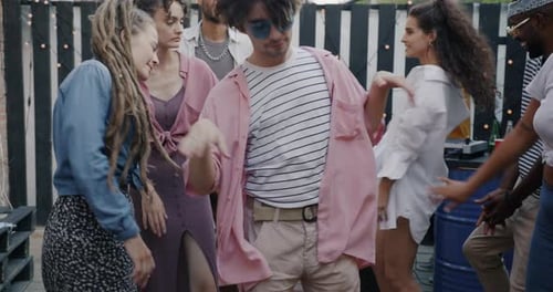 Slow Motion Portrait of Creative Young Man Student Dancing with Friends Outdoors in Cafe Terrace