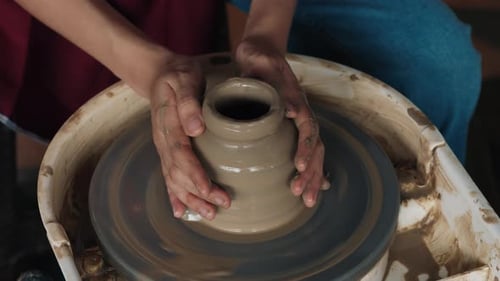 Hands Shape Clay on Pottery Wheel