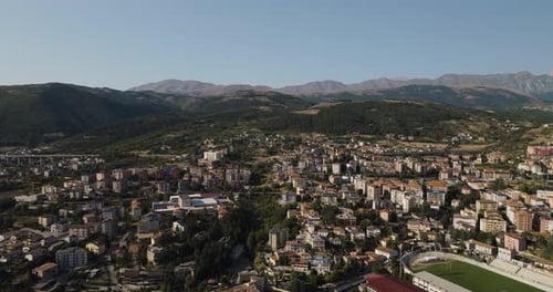 Aerial view of cityscape near mountains, Italy.