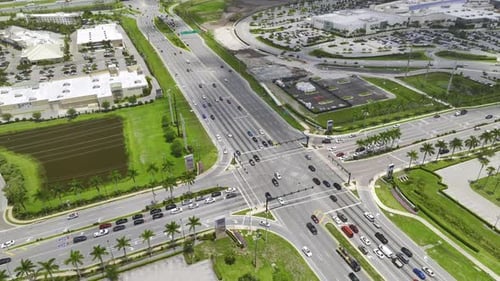 Aerial View of Large Multilane Road Intersection with Traffic Lights and Moving Cars and Trucks