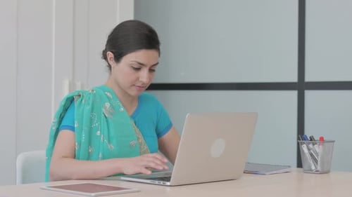 Woman in Sari Using Laptop in Office