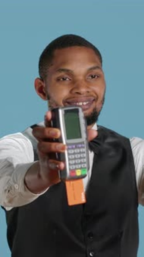 Vertical Video Hotel Porter Showing Pos Terminal with Card to Symbolize Electronic Transaction