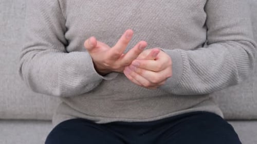 Hands Stretching Fingers at Home