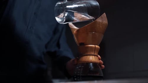 Pouring Hot Water Into Coffee Filter Maker