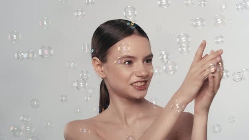 Woman Posing with Bubbles in Studio