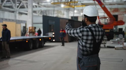 Indian Worker Supervising Modular Home Loading Process