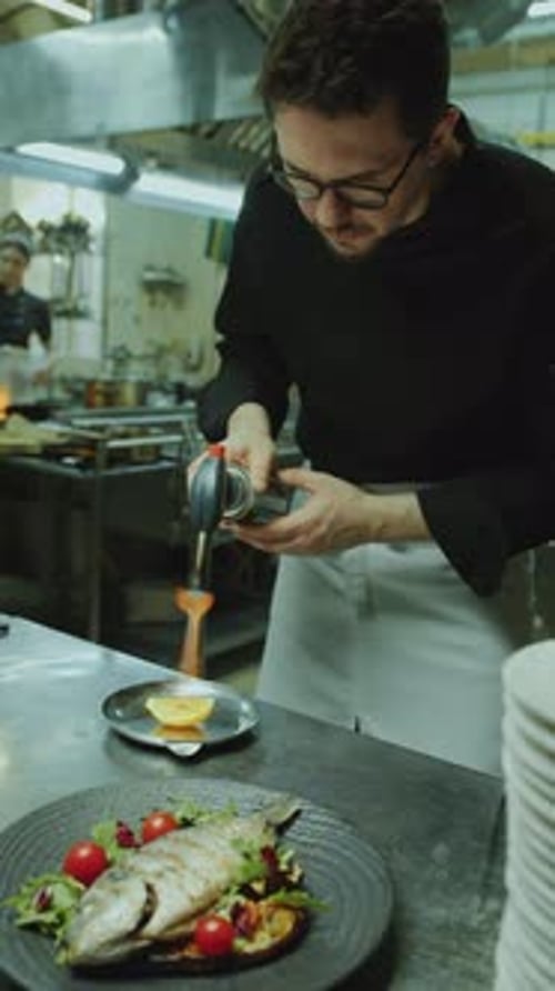 Chef Prepares Elegant Fish Dish with Blowtorch
