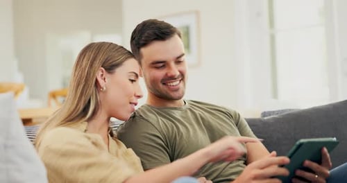 Couple Relaxing at Home Using a Tablet