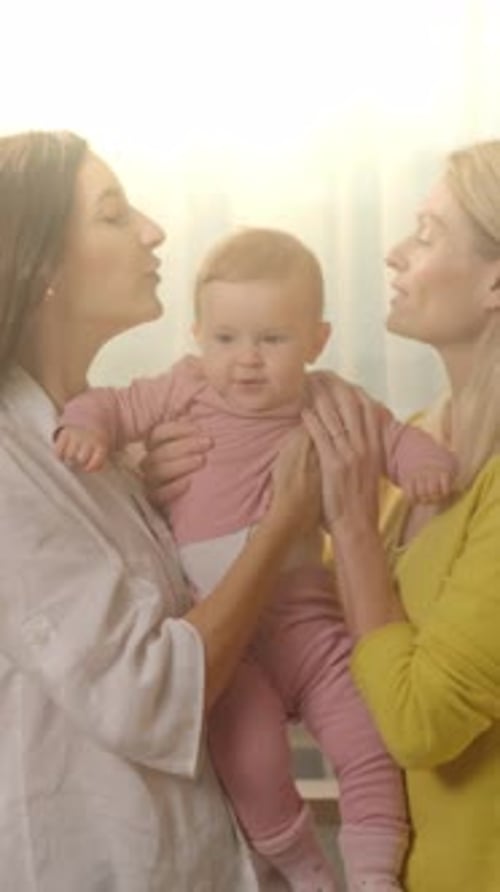 Loving Women Holding Adorable Baby Indoors Near Bright Window