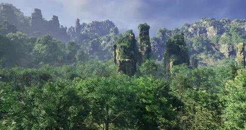 Lush Green Forest with Towering Rock Formations Under a Clear Blue Sky
