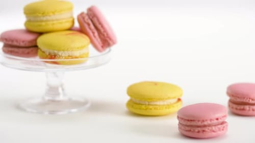 Pink and Yellow Macarons on White Background