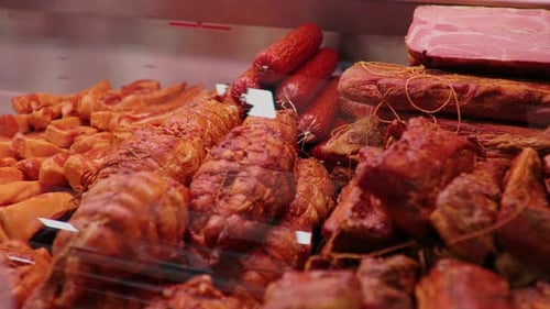 Showcase window of diverse meat production in butchers shop.