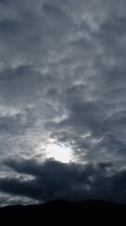 Ominous Clouds with Sunburst in Vertical Format