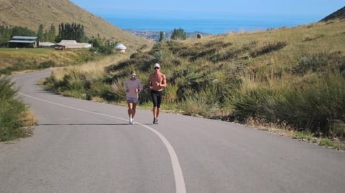 A Couple Jogs Together Enjoying a Scenic Route with Fresh Air and Vibrant Nature