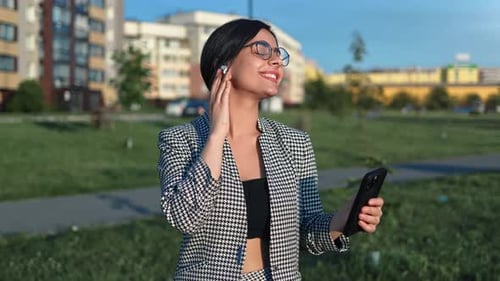 Stylish Brunette Woman Relaxing Outdoor City Park Listening Music Earphones Smartphone Application