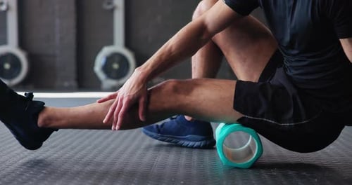 Man, legs or foam roller in gym for fitness, muscle knot relief or massage for tension