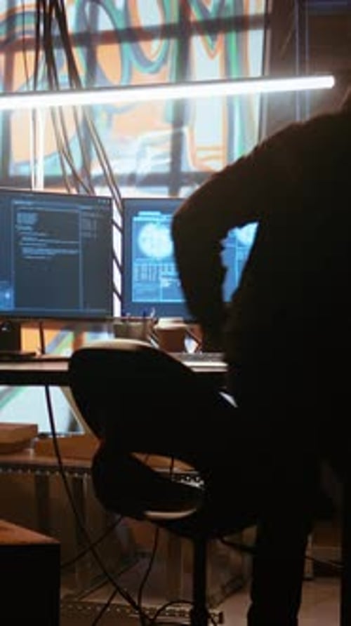 Vertical Video Hacker Arriving in Messy Base of Operations with Neon Lights and Graffiti Art
