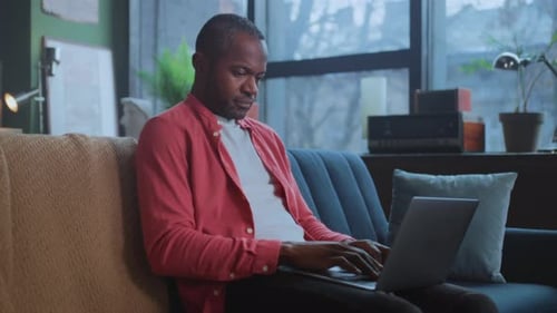 Man Working on Laptop Computer from Home