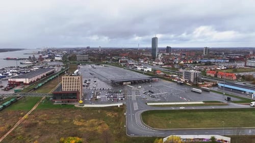 An aerial view of the ferry terminal with its entrances and a large parking area for the transport p