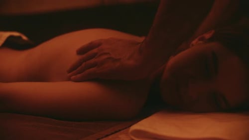 Pretty woman enjoying relaxing body massage at luxury health spa retreat