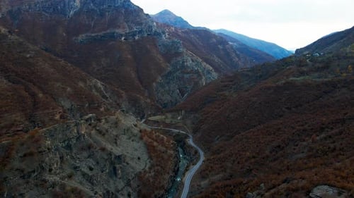 Aerial View of a Winding Road Through Mountain Valley