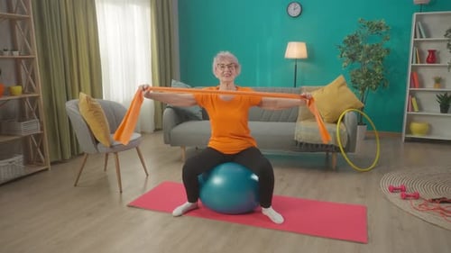 Senior Woman Exercising with Resistance Band at Home