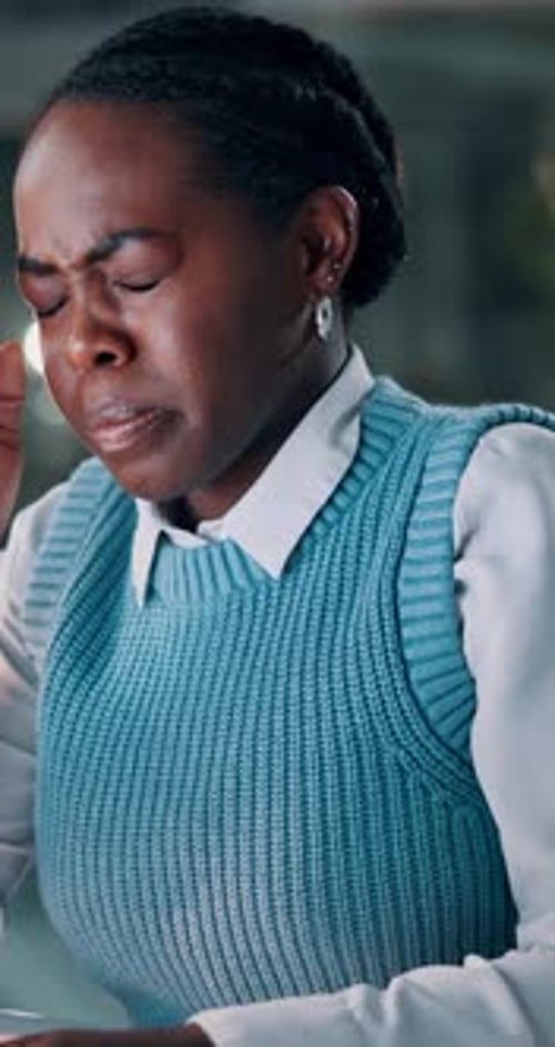 Headache, night or black woman in office with stress, overworked or pressure in missed deadline