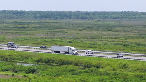Semi Truck Driving on Interstate Freeway Hauling Cargo Delivering Loads Concept