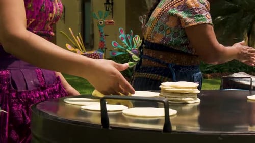 Women Making Tortillas on a Comal Outside