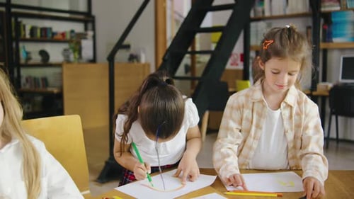 Children Drawing Together in Library Classroom