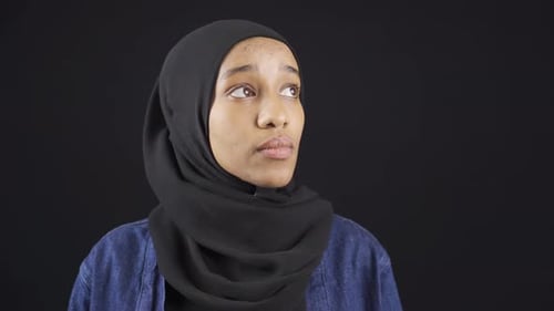 Woman in Hijab Looks Upward