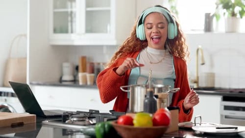 Woman Cooking and Dancing in Kitchen with Headphones