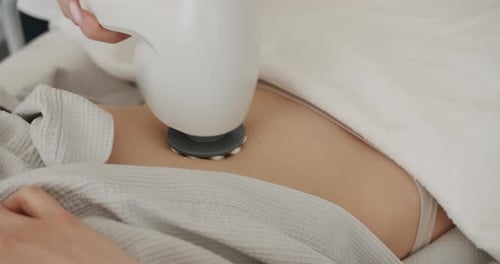 Woman Receiving Abdomen Treatment in Clinic