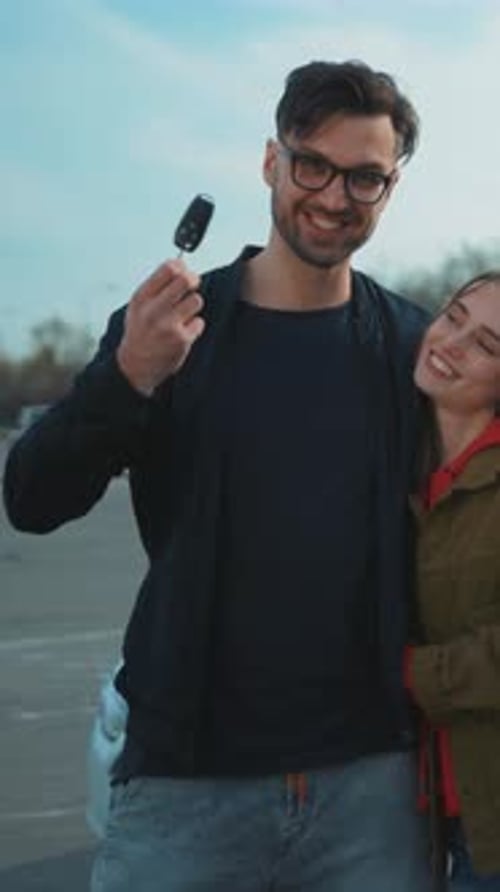 Happy Couple with Car Keys in the City