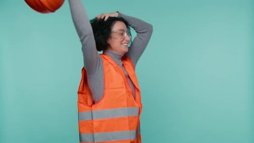 Mature Female Industrial Engineer in Orange Hard Hat Safety Vest Happily Dancing