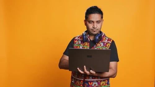 Man Typing on Laptop Frustrated with Malfunctioning Keyboard