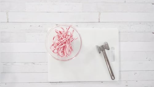 Breaking Candy Canes for Holiday Baking Preparation