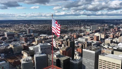 Aerial View of US Flag over Baltimore Skyline