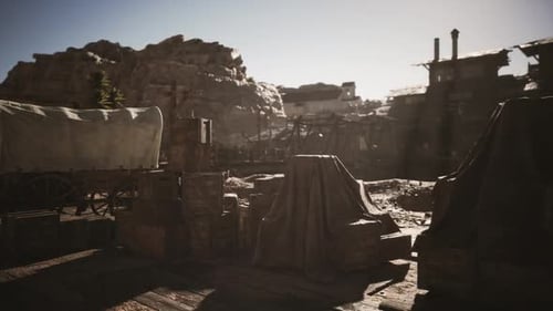 Old Western Town Setting with Wagons and Crates Under Bright Daylight