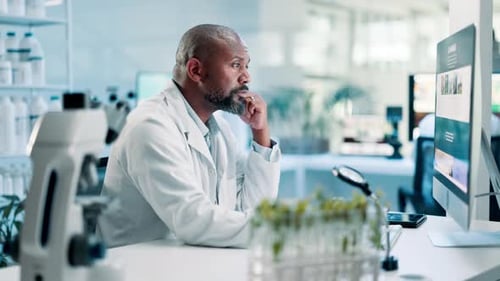 Man Working on Computer in Bright Laboratory