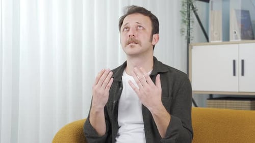 Man with Mustache Looks Sad and Contemplates