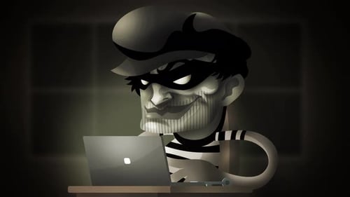 scammer thief using a computer to hack and steal