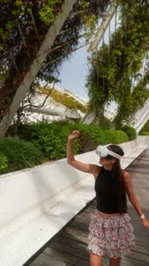 Woman Uses VR Headset in Futuristic Park
