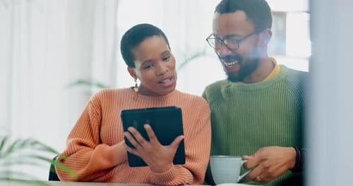 Happy Couple Using Tablet at Home