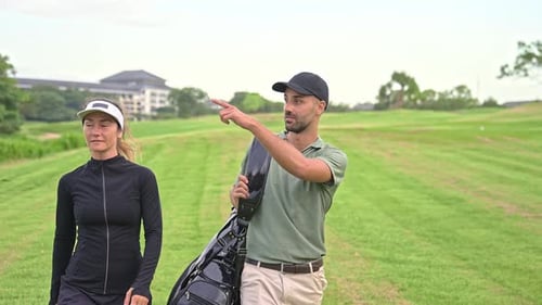 People Walking at Golf Course Look to Play Game with Ball and Carry Clubs in Bag