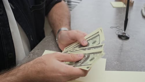 Counting Dollar Banknotes during Visit in Bank Office
