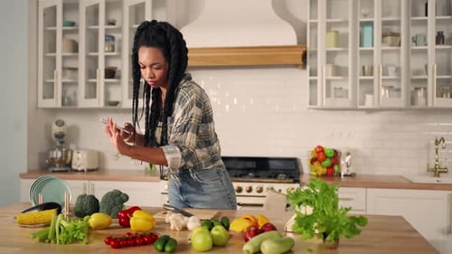 Young Adult with Fresh Vegetables in Modern Kitchen