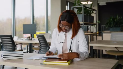 African American Medical Student Studying in University Library