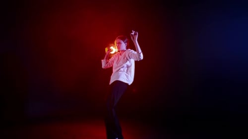 Woman Dances in the Dark on a Stage