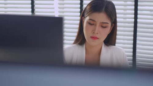 Asian beautiful businesswoman using laptop computer working in office.